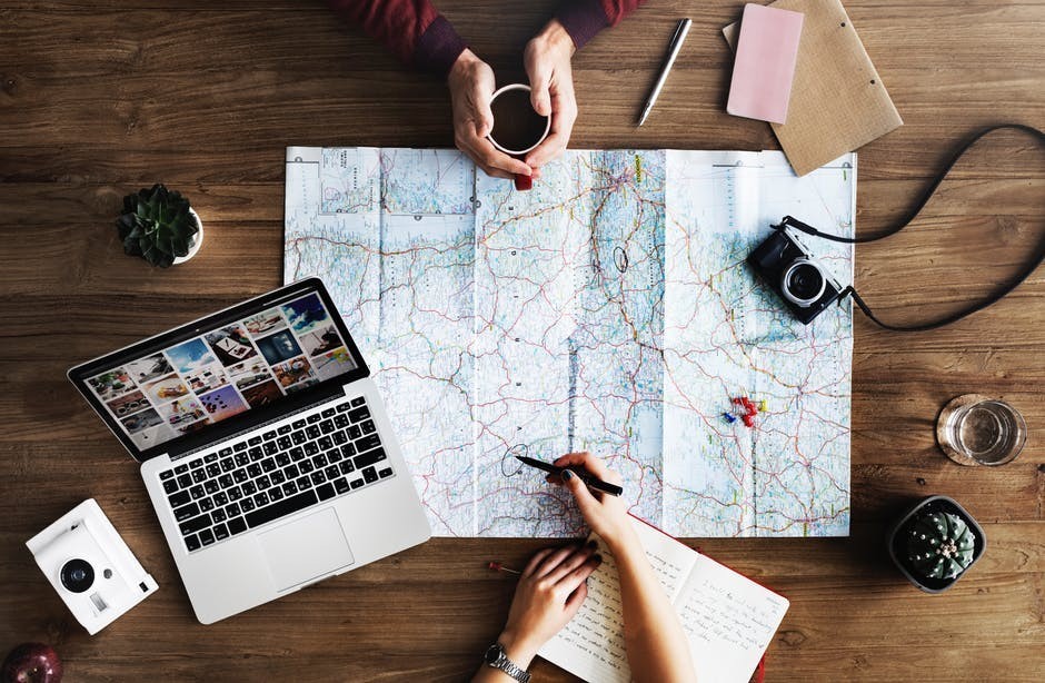 Travel planning and blogging using maps and laptops